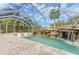 Inviting pool area with waterfall feature and covered lanai at 2501 Broad St, Nokomis, FL 34275