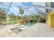 Enclosed pool and spa with waterfall feature and lounge chairs at 2501 Broad St, Nokomis, FL 34275