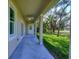 Covered patio with ceiling fan and access to backyard at 2793 Abbeville Rd, North Port, FL 34288