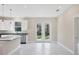 Bright kitchen with island and French doors leading to backyard at 2814 Daphne Rd, North Port, FL 34288