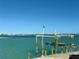 Waterfront property featuring a boat dock and lift with scenic water views of the city skyline at 3200 Higel Ave, Sarasota, FL 34242