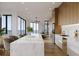 Bright, modern kitchen with a large marble island, sleek cabinets, and hardwood flooring at 3200 Higel Ave, Sarasota, FL 34242