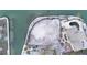 Aerial view of waterfront land with a pool, bordered by a seawall, perfect for building a dream home at 3200 Higel Ave, Sarasota, FL 34242