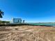 A waterfront lot ready for your dream home with stunning water views and a modern home to the right at 3200 Higel Ave, Sarasota, FL 34242