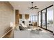 Inviting living room featuring a comfortable sofa, stylish decor, and large windows with ocean views at 3200 Higel Ave, Sarasota, FL 34242