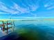 Beautiful water view, featuring a rustic dock and calm waters, ideal for enjoying peaceful waterfront moments at 3200 Higel Ave, Sarasota, FL 34242