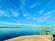 Serene waterfront view with clear skies, a calm canal, and distant city skyline, offering tranquility at 3200 Higel Ave, Sarasota, FL 34242