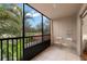 Screened balcony with patio furniture and treetop views at 3700 S Osprey Ave # 214, Sarasota, FL 34239