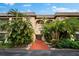 Two-story condo building with lush landscaping at 3700 S Osprey Ave # 214, Sarasota, FL 34239