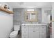 Updated bathroom featuring a sleek vanity, framed mirror, modern fixtures, and tiled floors at 3700 S Osprey Ave # 214, Sarasota, FL 34239