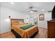 Cozy bedroom featuring a wood frame bed, ceiling fan and natural lighting at 3700 S Osprey Ave # 214, Sarasota, FL 34239