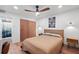 Comfortable bedroom with hardwood floors, ceiling fan, closet and minimalist decor at 3700 S Osprey Ave # 214, Sarasota, FL 34239