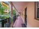 Hallway features a peach-colored corridor with exterior views and a welcome mat, leading to residences at 3700 S Osprey Ave # 214, Sarasota, FL 34239