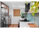 Galley kitchen with stainless steel refrigerator and range, quartz countertops, and stylish backsplash at 3700 S Osprey Ave # 214, Sarasota, FL 34239