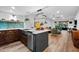 Modern kitchen featuring quartz countertops, stainless steel appliances, and an open layout to the living area at 3700 S Osprey Ave # 214, Sarasota, FL 34239