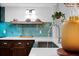 Bright, updated kitchen featuring quartz counters, stainless sink, and open shelving for added storage at 3700 S Osprey Ave # 214, Sarasota, FL 34239