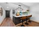 Stylish kitchen island featuring a wine rack, barstool seating, and access to main living area at 3700 S Osprey Ave # 214, Sarasota, FL 34239