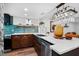 Modern kitchen highlighting a large island, stainless steel sink, and distinctive blue tile backsplash at 3700 S Osprey Ave # 214, Sarasota, FL 34239