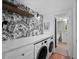 Laundry room with white marble counter tops and forest wallpaper at 3700 S Osprey Ave # 214, Sarasota, FL 34239