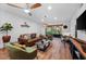Spacious living room with leather sofa, wood floors, and stylish decor at 3700 S Osprey Ave # 214, Sarasota, FL 34239