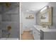 Updated bathroom with gray tile, white vanity, and gold fixtures at 3700 S Osprey Ave # 214, Sarasota, FL 34239