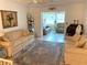 Bright living room with ample seating and access to a sunroom at 390 301 W Blvd # 27B, Bradenton, FL 34205