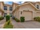 Front view of a tan townhome with double garage and landscaped walkway at 4523 Cinnamon Dr # 2702, Sarasota, FL 34238