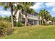 Back exterior view of the house with tropical landscaping at 4523 Cinnamon Dr # 2702, Sarasota, FL 34238