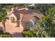 Luxury home with tile roof, pool, and circular driveway; located in a lush, tree-lined neighborhood at 5331 Siesta Cove Dr, Sarasota, FL 34242