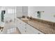 Bathroom with granite countertop and white cabinets at 5331 Siesta Cove Dr, Sarasota, FL 34242