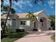One-story home with arched entryway, tile roof, and manicured landscaping at 5331 Siesta Cove Dr, Sarasota, FL 34242