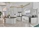 Large kitchen with granite countertops, white cabinets, and an island at 5331 Siesta Cove Dr, Sarasota, FL 34242