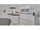 Modern kitchen featuring granite countertops, white cabinetry, and high-end appliances at 5331 Siesta Cove Dr, Sarasota, FL 34242