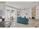 Bright living room with vaulted ceilings, fireplace and teal sofa at 5331 Siesta Cove Dr, Sarasota, FL 34242