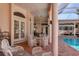 Relaxing patio with pool view and wicker furniture at 5331 Siesta Cove Dr, Sarasota, FL 34242