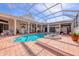 Inviting kidney shaped pool with a spa and screened enclosure at 5331 Siesta Cove Dr, Sarasota, FL 34242