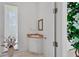 Small powder room with corner sink and white vanity at 5331 Siesta Cove Dr, Sarasota, FL 34242