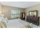 Bright bedroom with a king-size bed, dresser, and large window at 5352 Fairfield Blvd, Bradenton, FL 34203