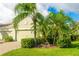 Single-story home with a two-car garage and tropical landscaping at 5352 Fairfield Blvd, Bradenton, FL 34203