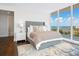 Bright bedroom with water views and large windows at 540 N Tamiami Trl # 1201, Sarasota, FL 34236