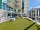 Relaxing rooftop terrace with artificial turf, seating areas, and city views at 540 N Tamiami Trl # 1201, Sarasota, FL 34236