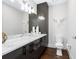 Modern bathroom with marble countertop and dark vanity at 540 N Tamiami Trl # 1201, Sarasota, FL 34236
