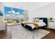 Spacious bedroom with a blue velvet bed and city views at 540 N Tamiami Trl # 1201, Sarasota, FL 34236