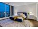 Elegant bedroom with a blue velvet bed and city views at 540 N Tamiami Trl # 1201, Sarasota, FL 34236
