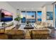 Living room with stunning sunset view and comfy seating at 540 N Tamiami Trl # 1201, Sarasota, FL 34236