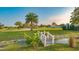 Landscaped front yard with a bridge and pond at 6722 Hawkins Rd, Sarasota, FL 34241