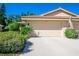 Attached garage with a single door and landscaped surroundings at 7187 Wood Creek Dr # 10, Sarasota, FL 34231