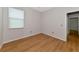 Simple bedroom with wood-look floors and a window with blinds at 7746 108Th Avenue E Cir, Parrish, FL 34219