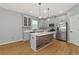 Island kitchen with stainless steel appliances and wood-look flooring at 7746 108Th Avenue E Cir, Parrish, FL 34219