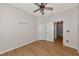 Bright bedroom with wood-look floors, ceiling fan, and double closets at 7746 108Th Avenue E Cir, Parrish, FL 34219
